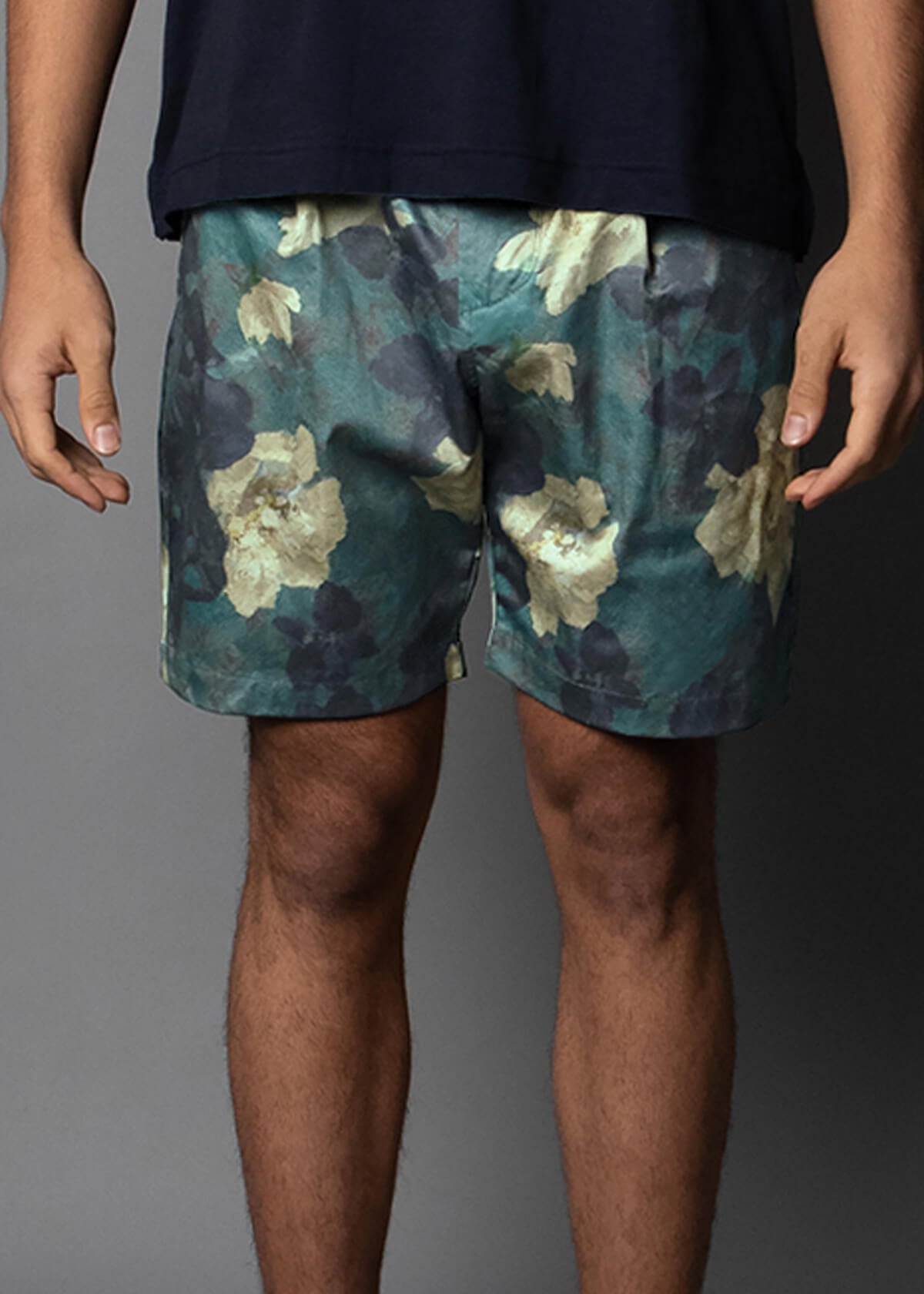 men's short with an oil painted floral pattern in green and blue tones